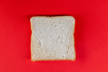 Sliced bread on red background.