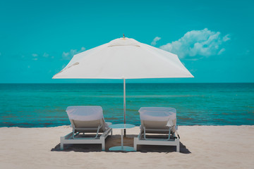 Two beach chairs on tropical vacation, relax at sea
