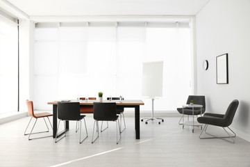 Simple office interior with large table and chairs