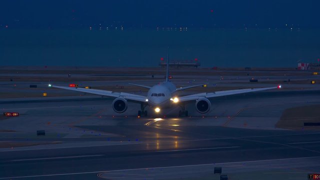 Night Time Generic Unmarked Airliner Taxiing at Airport near San Francisco with Airfield and Airplane Lights in a Vibrant California Evening Setting