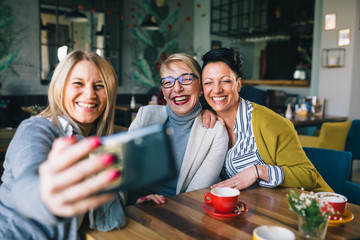 women friends having fun in cafe
