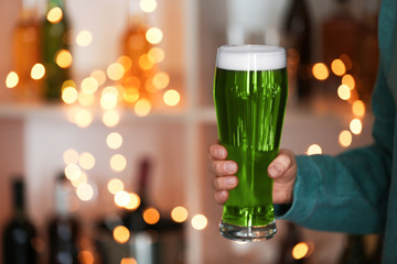 Closeup view of woman with green beer in pub, space for text. St.Patrick's Day celebration