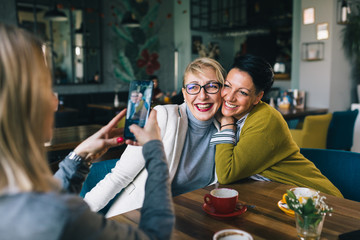 women friends having fun in cafe