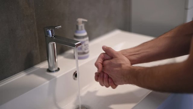 Corona virus prevention man washing hands with soap