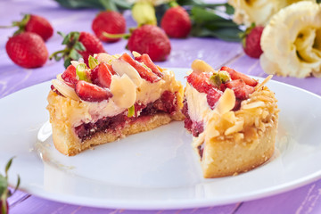 Сut of mini tart cupcake with strawberries on plate. Close up.