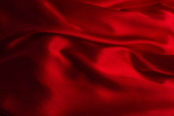 Naklejka na ściany i meble Red silk or satin luxury fabric texture can use as abstract background.