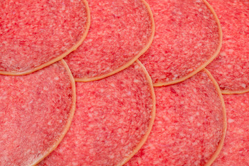 Tasty salami slices background.