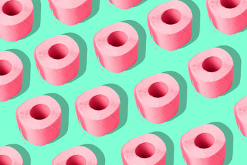 Toilet paper on a colored background. A repeating roll of pink paper. Contemporary art, minimalism.