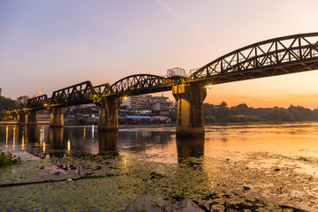 Fototapeta na wymiar The Bridge on the River Kwai Built during World War II. Is an important place and a destination for tourists from around the world. Sunset or sunrise time