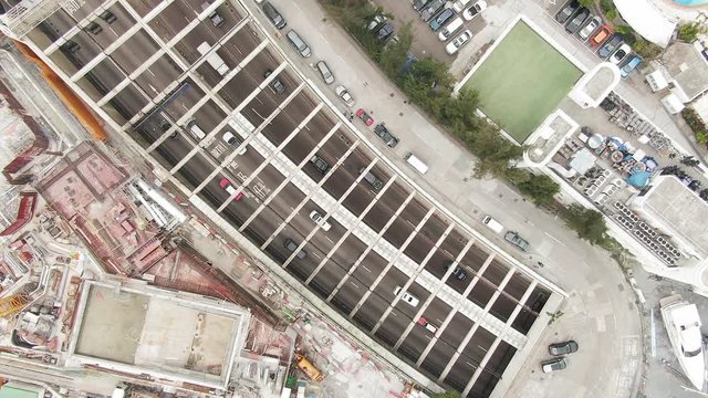 Traffic heading in and out of Cross Harbour Tunnel, Causeway Bay, Downtown Hong Kong, Top down aerial view.