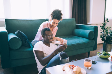 Happy multiethnic couple having fun at home