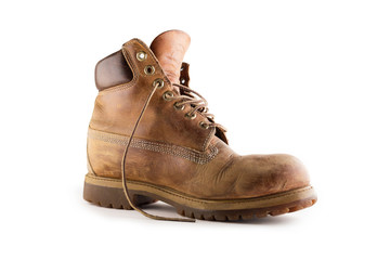 Old leather brown boots isolated in a white background.