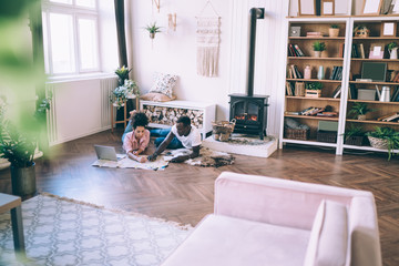 Multiracial couple studying map planning trip