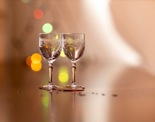 Everything prepared for a party, glasses, masks, lights and fruit with their reflections.