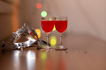 Everything prepared for a party, glasses, masks, lights and fruit with their reflections.