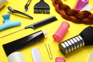 Fototapeta na wymiar Professional tools for hair dyeing on yellow background