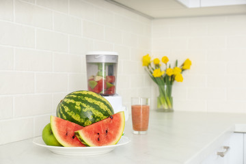Blender and smoothie ingredients on counter in kitchen