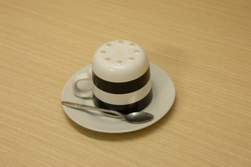 The black and white patterned tea cups were laid upside down, along with silver spoons, prepared in a mini-mallet for the beginning of a new morning's life.