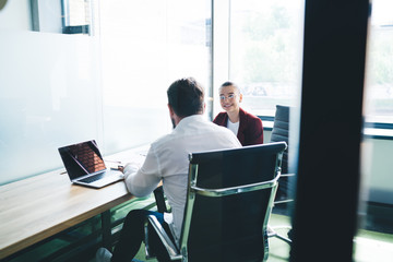 Boss talking to secretary in office