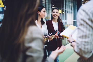 Smiling employees having discussion on work related topics