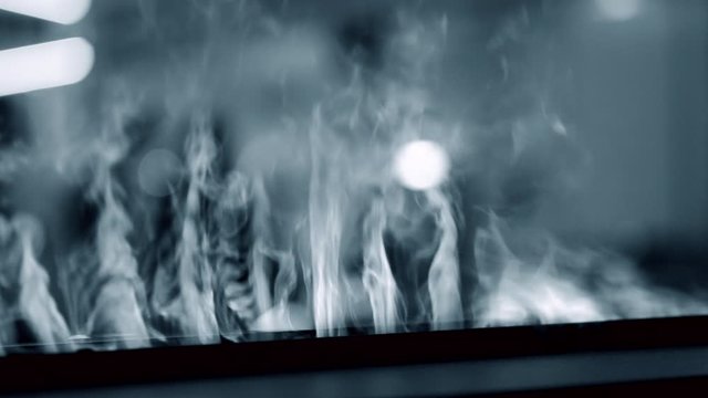 Artificial electrofireplace glowing backlight close-up.