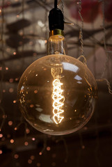 Luminous thread of a retro Edison lamp on a dark background