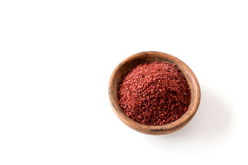 Obraz na płótnie Canvas Sumak - a spice from the ground berries of one of the types of sumac reddish-burgundy with a sour taste. It is used in Turkish and Levantine cuisine for salad dressing. Copy space.