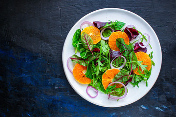 healthy salad tangerines citrus, lettuce, arugula and other herbs. Menu concept food background,...