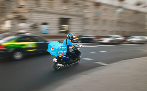 Minsk, Belarus. Jun 2019. Domino's Delivery Bike On The Road. Delivery Man Riding Moto Bike, With Motion Blur Effect. Food Supplier Driving Fast On Motorcycle To Bring Food To Customer Quickly