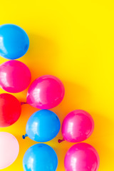 Colorful balloons frame on yellow background top-down frame copy space