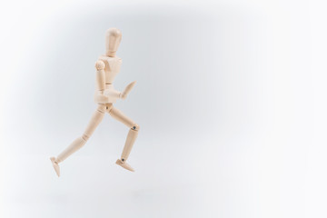 Wooden dummy proudly presents some invisible thing, isolated on white background, copy space for your object or text
