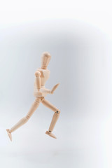 Wooden dummy proudly presents some invisible thing, isolated on white background, copy space for your object or text