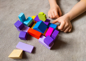A child is playing withcolorful heart with colorful wooden building blocks. World autism awareness...