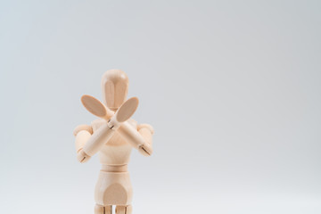 Refusal gesture, Wooden dummy, crossed hands on white background, copy space for your object or text