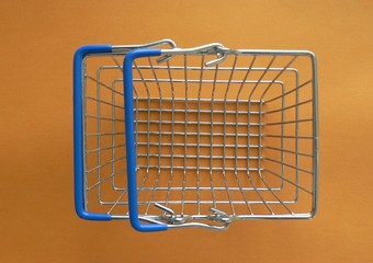 Empty shopping basket on colorful background. Shop trolley at supermarket. Sale, discount, shopaholism, black friday, economy concept. Consumer society trend. Online Shopping Concept.
