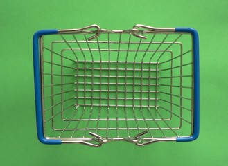 Empty shopping basket on colorful background. Shop trolley at supermarket. Sale, discount,...