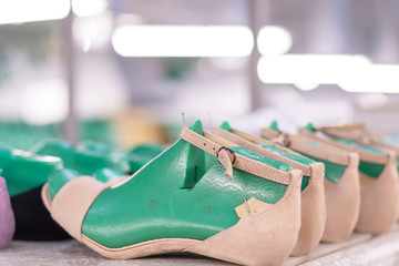 production line conveyor in footwear factory with leather shoe