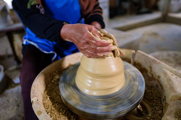 Closeup of Local woman demonstrates on making traditional clay jar called 