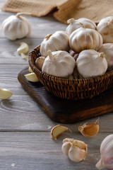 Healthy and wholesome food. Fresh garlic in a wicker basket on a wooden table