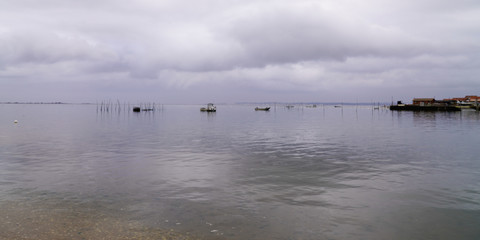 Lège-Cap-Ferret water boats reflection sky cloud in sea bay arcachon basin France