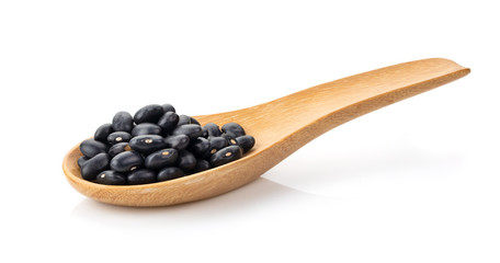 black beans in wood spoon isolated on white background