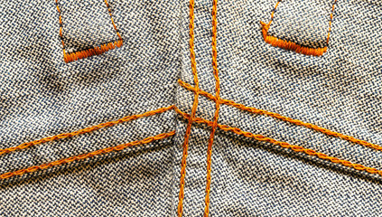 Jeans. Denim back, bright orange denim seam. Macro.