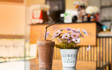 Chocolate Smoothie With plant pots on the dining table in the coffee shop with orange light