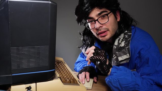 Computer geek from the 70s 80s talking to the camera about his vintage computer setup.