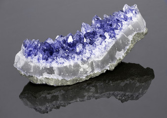 light sapphire in geode on dark background