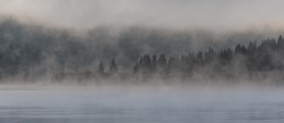 Misty mountain lake early morning 