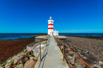 Red lighthouse on the island of Iceland