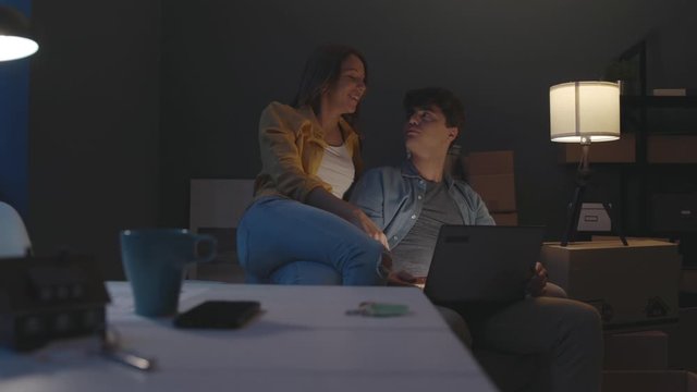 Couple in their new home connecting with a laptop