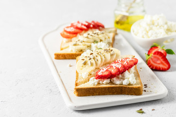 Strawberry banana goat cheese toasts. Selective focus, copy space.