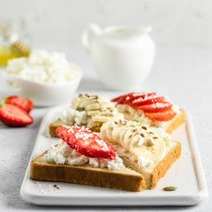 Strawberry banana cottage cheese crostini. Selective focus, copy space.